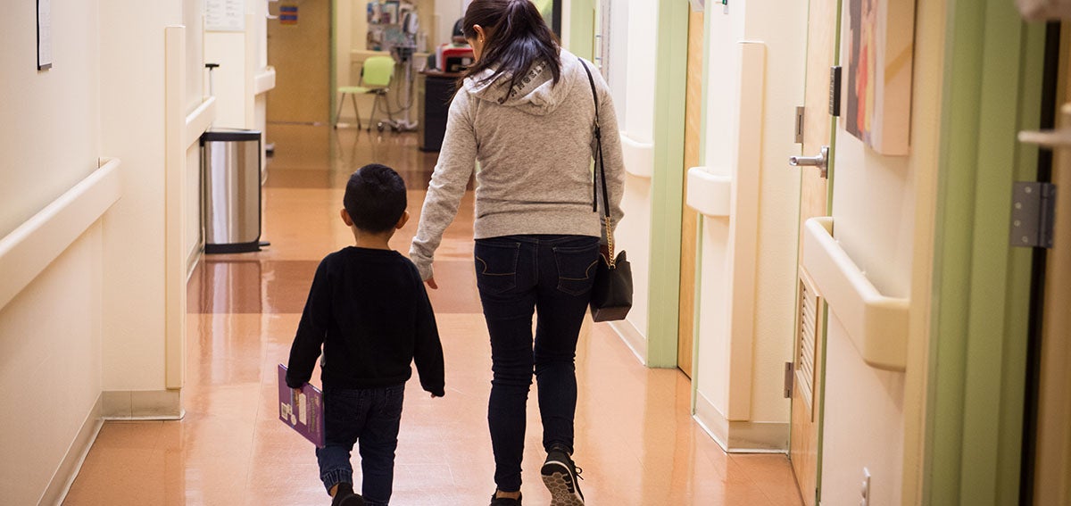 Mother and child walking away from doctor's office