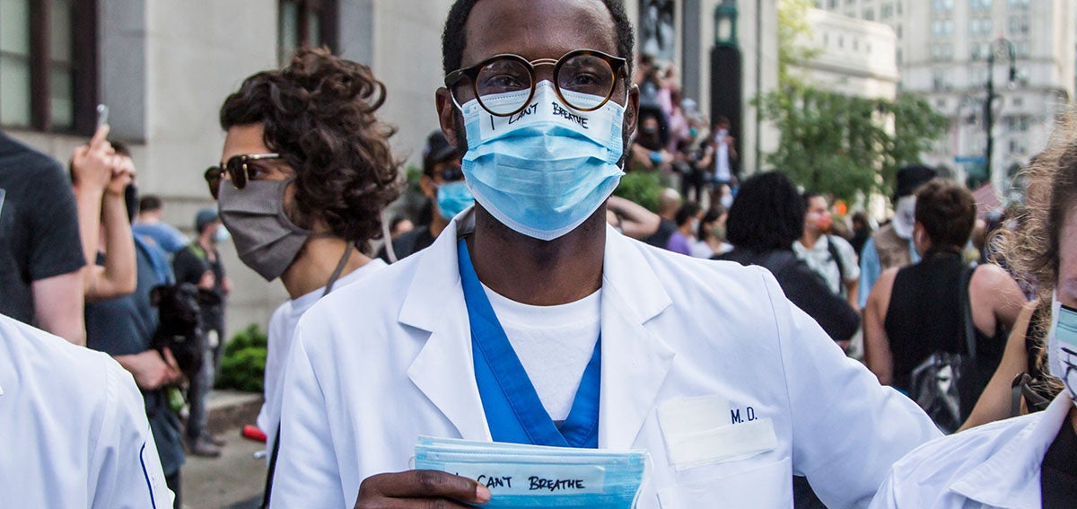 A Black physician protests in Brooklyn, New York. 