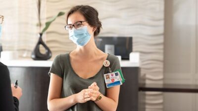 Nurses working with Project Roomkey talk in the lobby of a hotel. Photo: Alain McLaughlin Photography Inc. and Building Futures