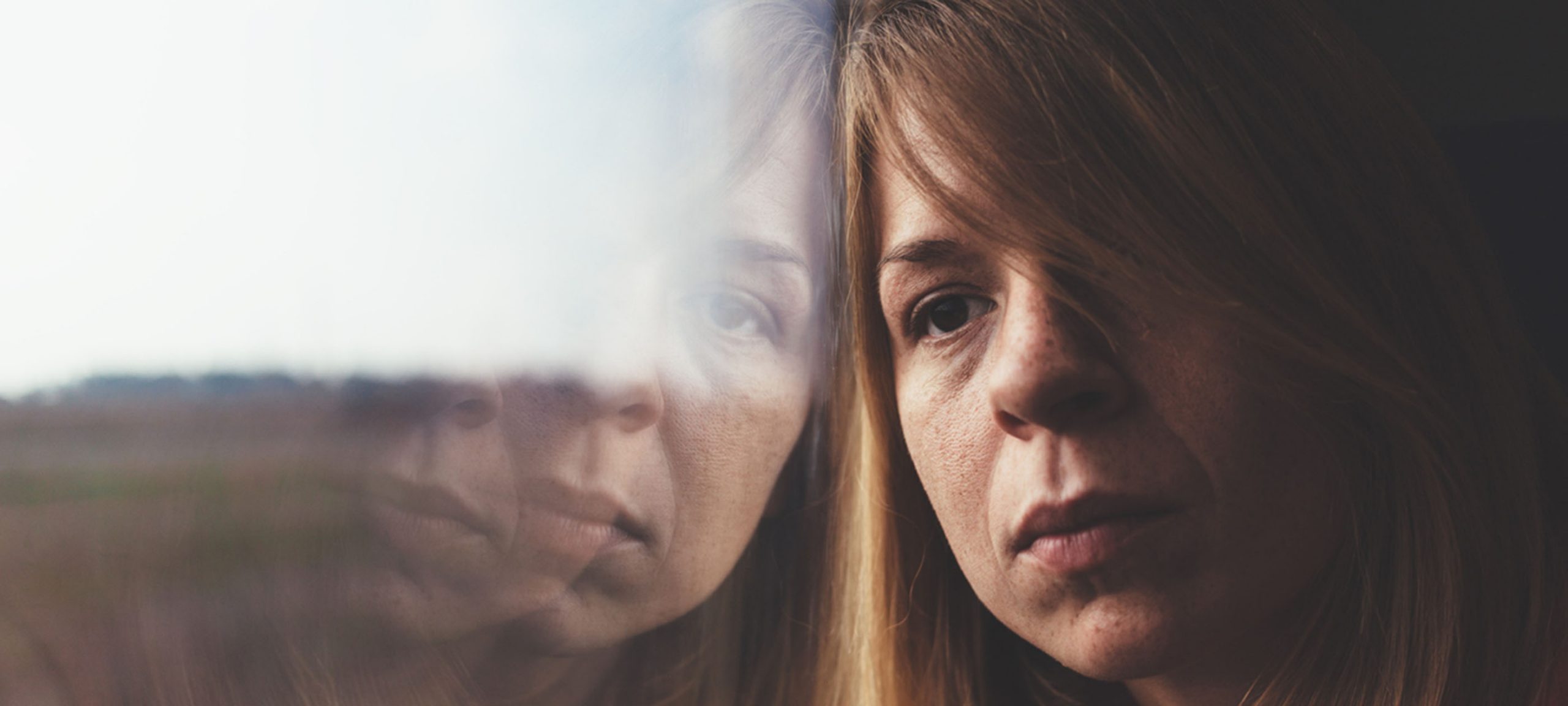 A woman looking out a window.
