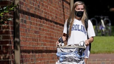 Student leaves campus following a cluster of COVID-19 cases at the University of North Carolina in Chapel Hill