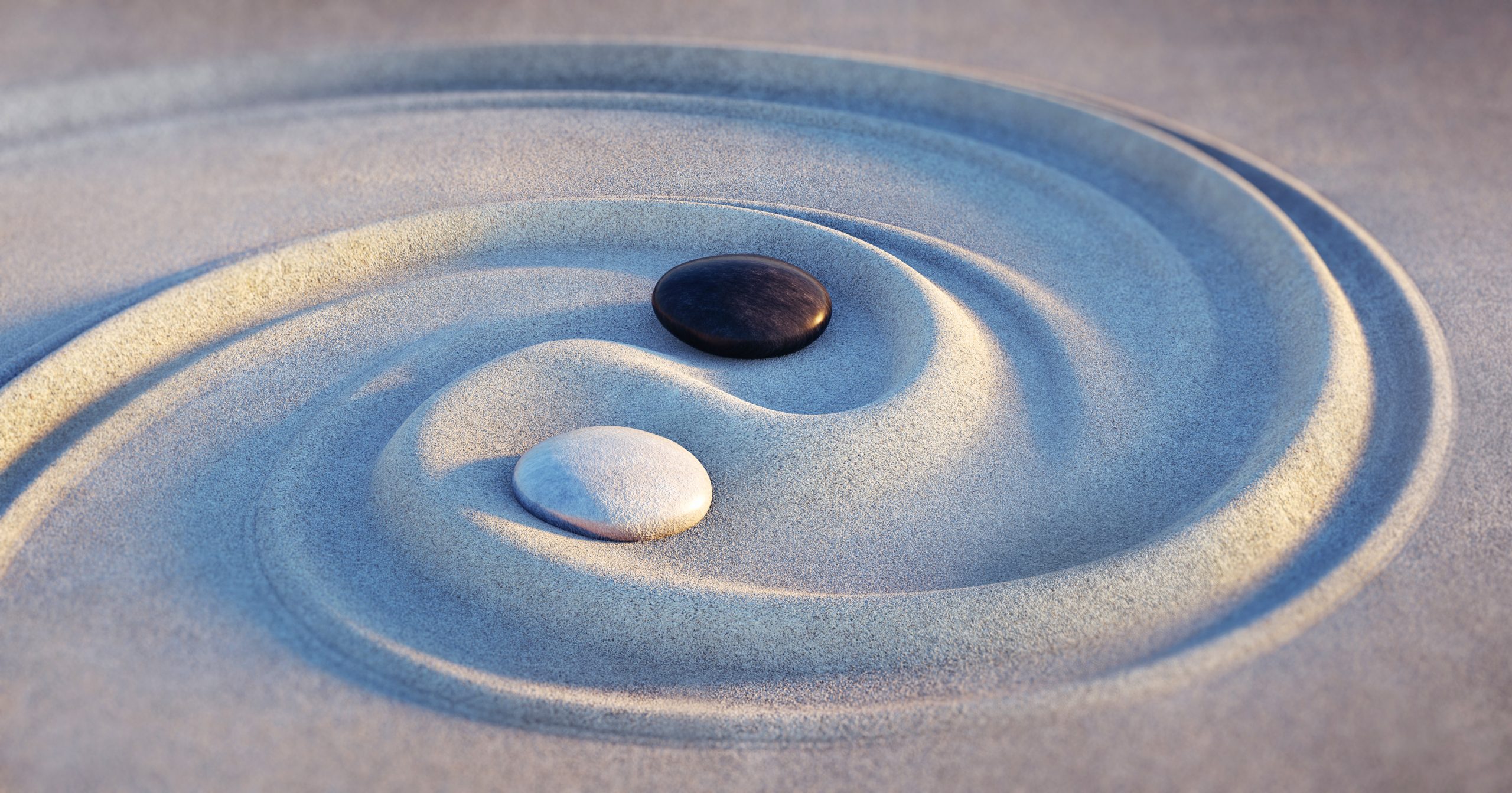 a swirl of sand with two rocks placed at the equilibrium point in the middle