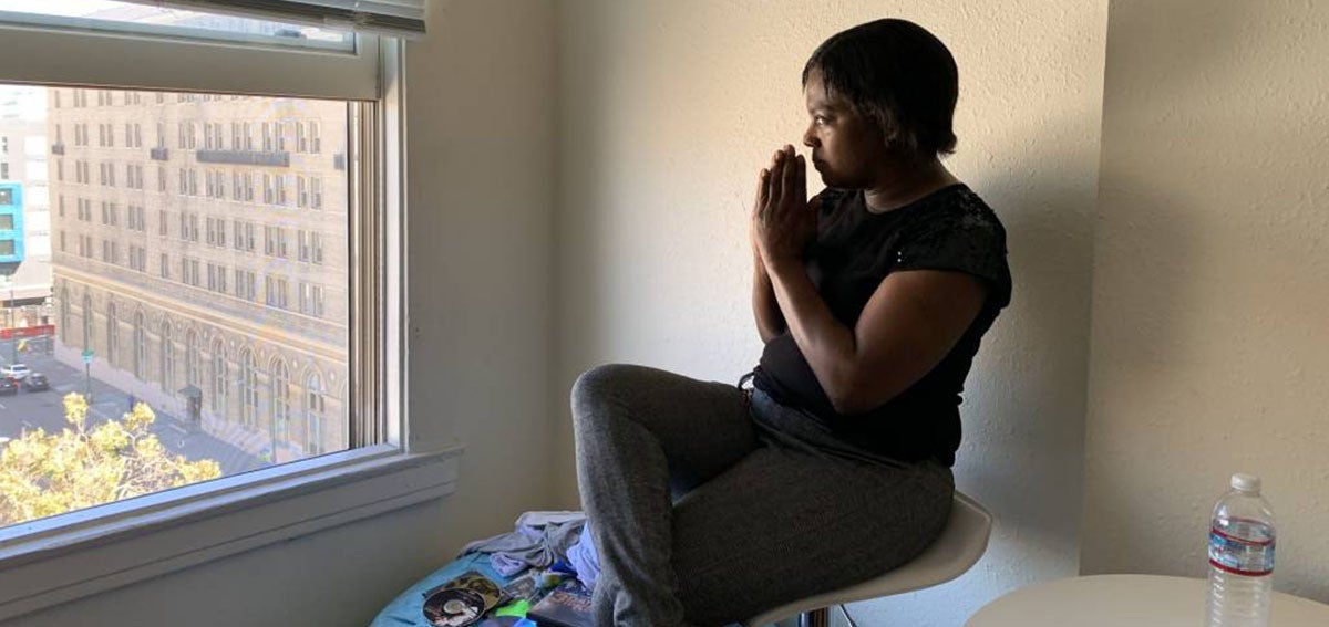 Sonja Summerville Trotter looks out the window in her new studio apartment in downtown Oakland