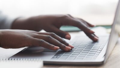 Hands typing on a keyboard