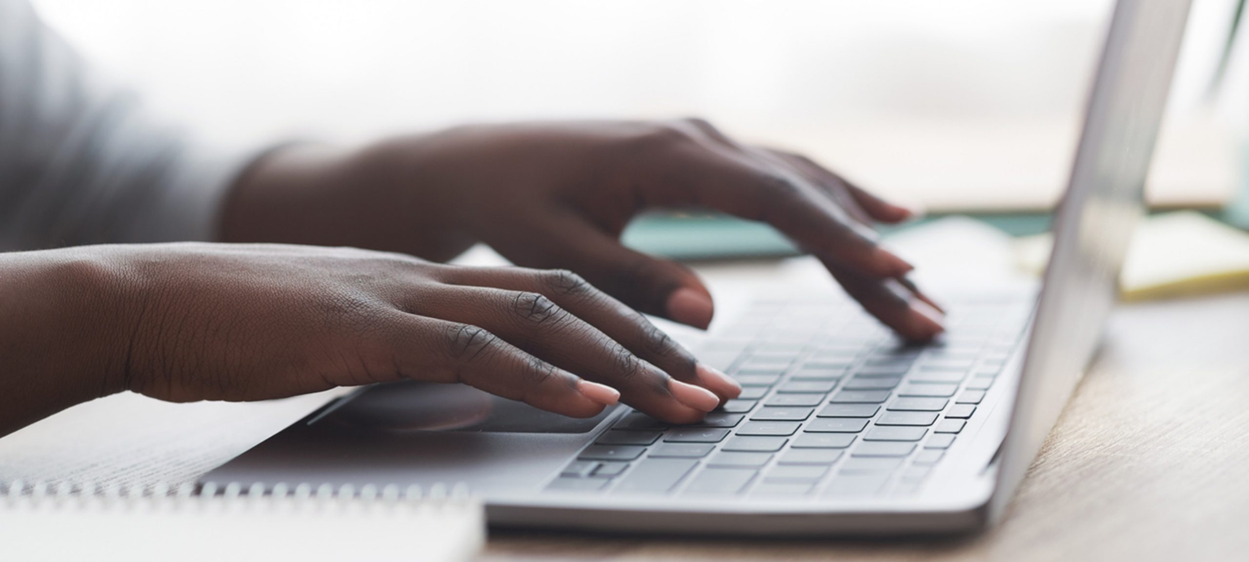 Hands typing on a keyboard