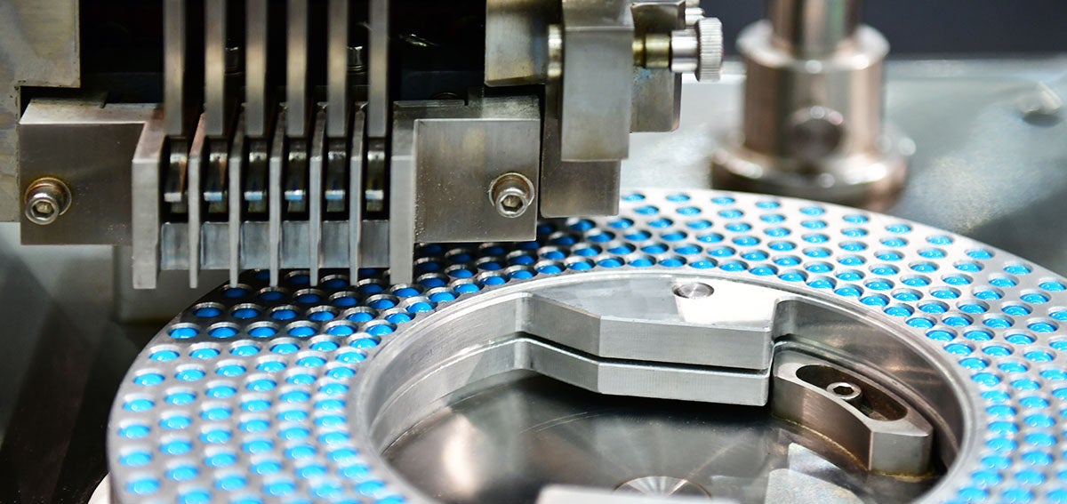 blue pills are sorted for packaging by machine