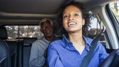 ride share driver drives elderly passenger to his destination