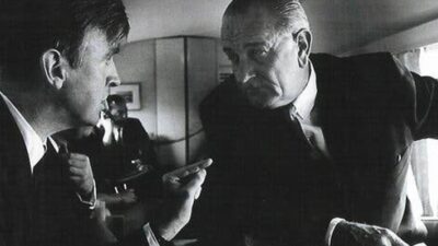 Phil Lee speaks with President Lyndon B. Johnson aboard Airforce One