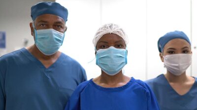 Three medical providers wearing surgical masks