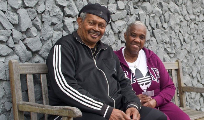 Rev. Johnnie Clark and Gloria Clark sit on a bench together.