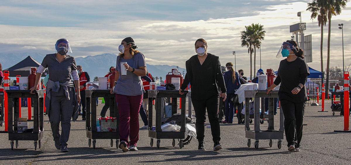 Healthcare workers on the way to their stations at COVID-19 vaccination event