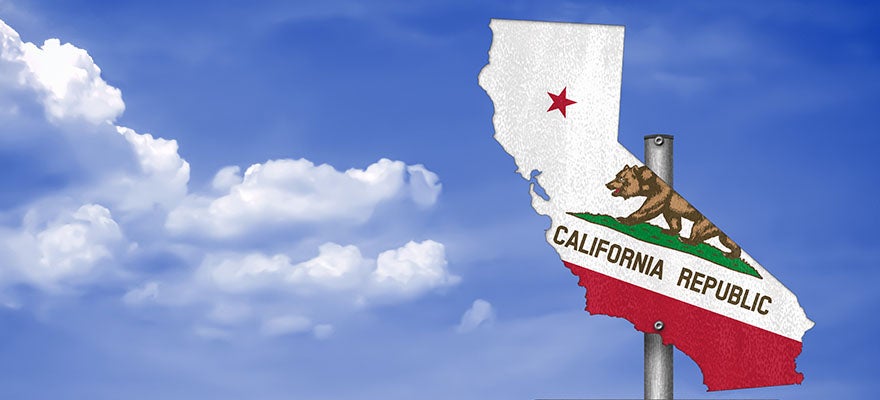 Signpost with a cutout of the state of California and the California flag on it