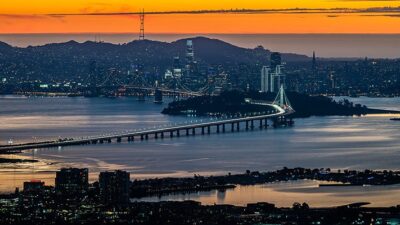Oakland/San Francisco Bridge with Emeryville waterfront in foreground and San Francisco in the distance