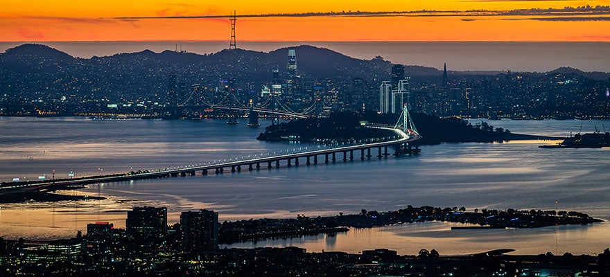 Oakland/San Francisco Bridge with Emeryville waterfront in foreground and San Francisco in the distance