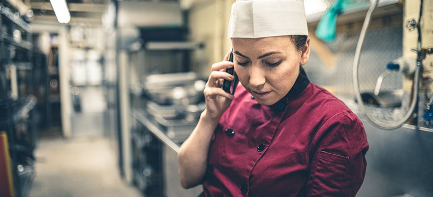 Chef taking a call on cellphone
