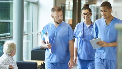 Medical students walk together through hospital