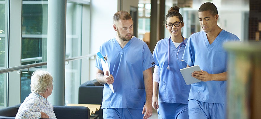 Medical students walk together through hospital
