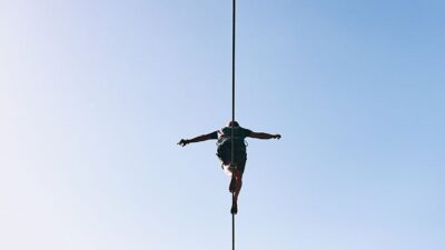 person walking on a slack line