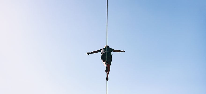 person walking on a slack line