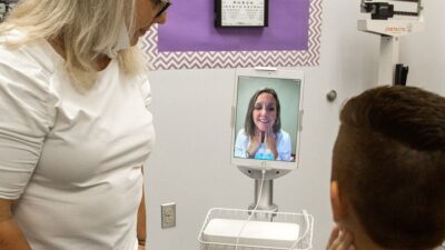Nurse and patient talking to doctor via telehealth visit
