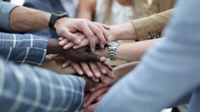 Close-Up of hands business team showing unity with putting their hands together.