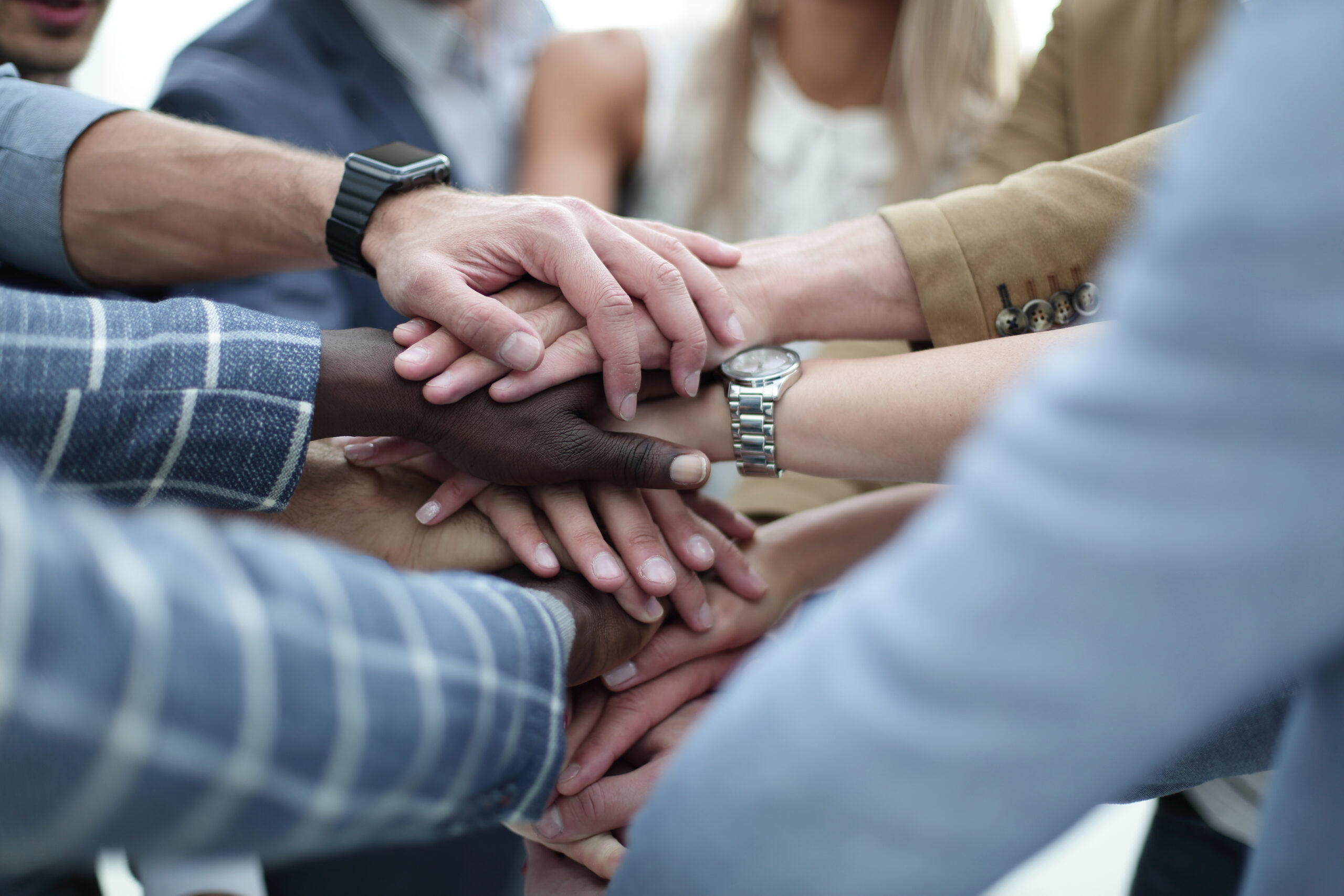 Close-Up of hands business team showing unity with putting their hands together.