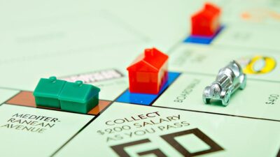 Plastic houses and hotels on Monopoly board