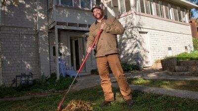 Robert Turner photographed raking leaves in front of home.