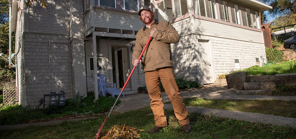 Robert Turner photographed raking leaves in front of home.