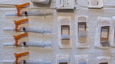 Syringes with prepared doses of the Johnson & Johnson Janssen Covid-19 vaccine and bandages
