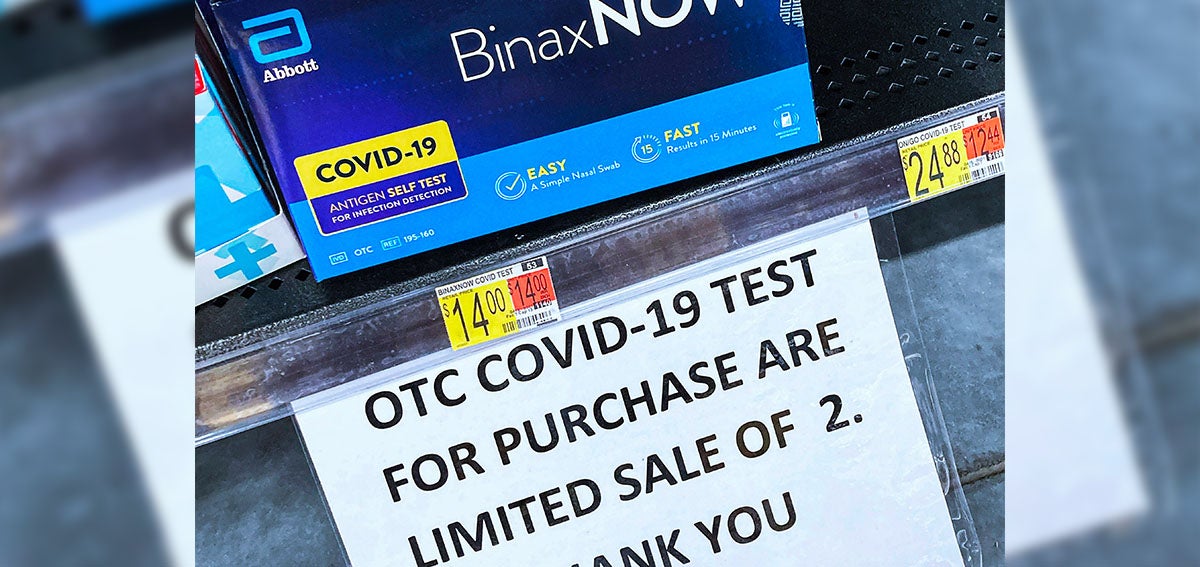 COVID-19 home test kits are seen on a shelf at a Walmart Neighborhood Market in Orlando, Florida.