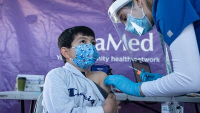 Young boy getting COVID-19 vaccination.