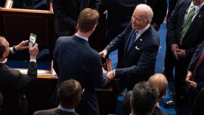President Biden shakes hands with various people after giving his State of the Union address during a joint session of Congress