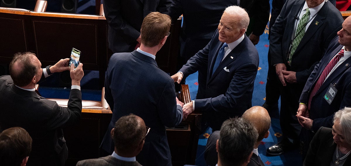 President Biden shakes hands with various people after giving his State of the Union address during a joint session of Congress