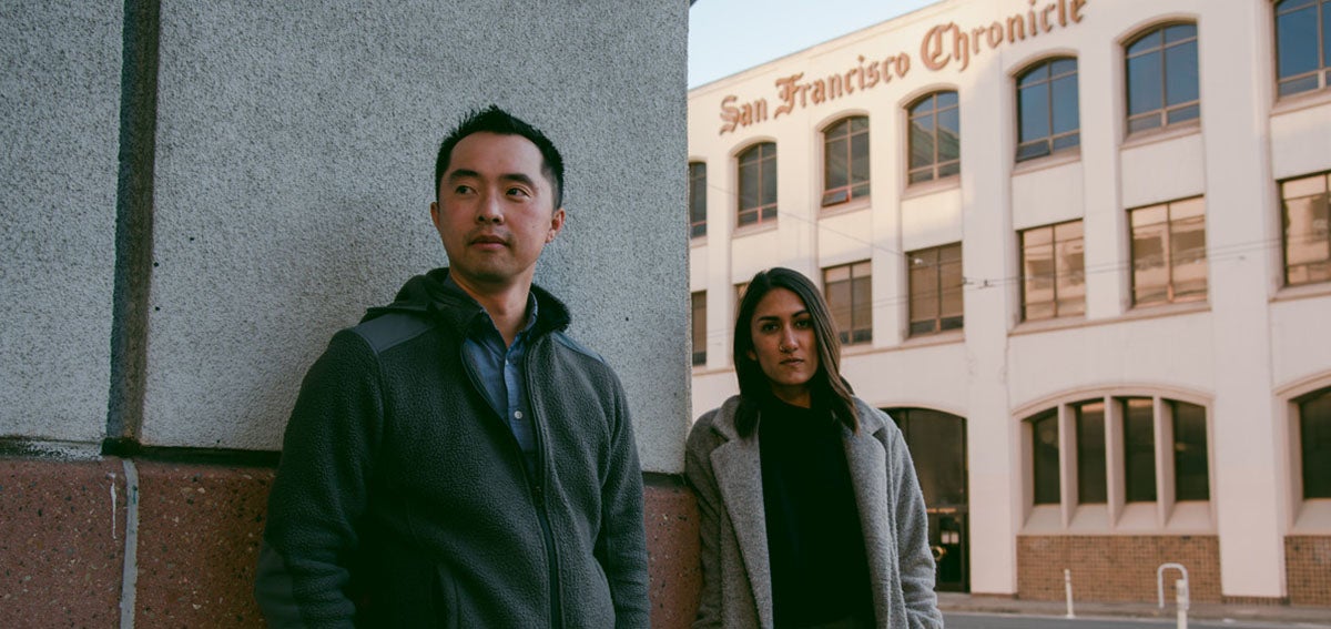 Journalists Trisha Thadani and Stephen Lam stand in front of the San Francisco Chronicle building.