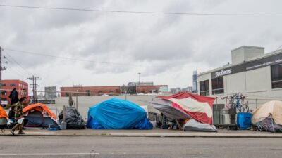 Homeless tents line city streets in San Francisco. Homeless community creates a camp with all their suitcases, tents, sleeping bags and precious belongings.