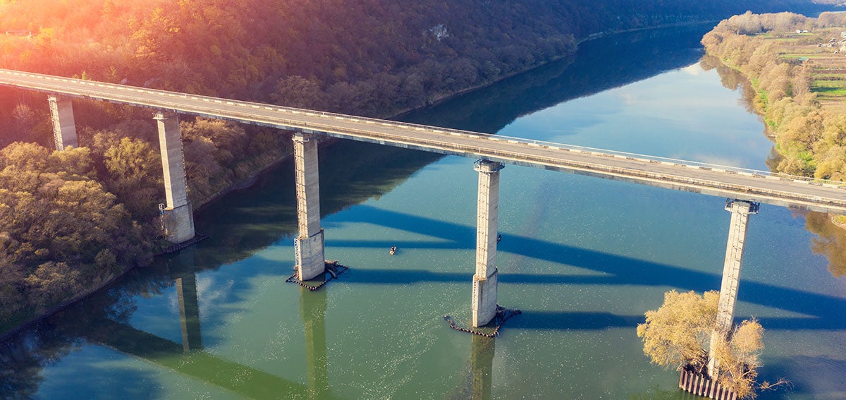 Overhead shot of a long bridge spanning a river