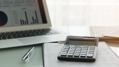 Spreadsheet on laptop and calculator