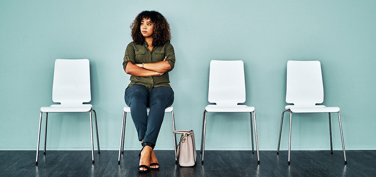 Woman sitting alone, in waiting room.