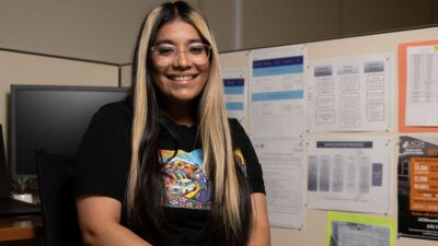 Daisy Amezcua sitting at her desk