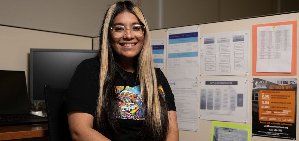 Daisy Amezcua sitting at her desk