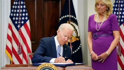 President Joe Biden signs into law S. 2938 as First Lady, Jill Biden watches