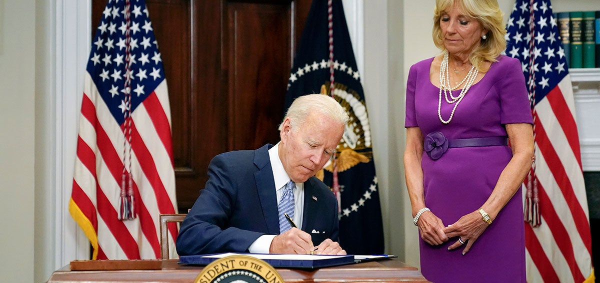 President Joe Biden signs into law S. 2938 as First Lady, Jill Biden watches