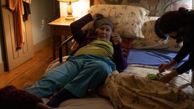 Elderly woman at home receiving medical care