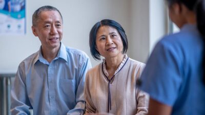 Older couple talk to medical practitioner