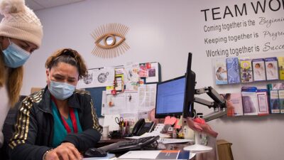 Women in health clinic look at paperwork together