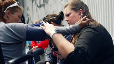 street medicine practitioner helps woman who is experiencing homelessness