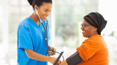 Medical practitioner checking patient's blood pressure