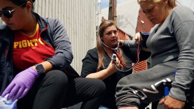 Street medicine team assists a woman experiencing homelessness.