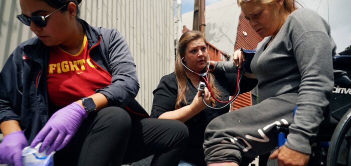 Street medicine team assists a woman experiencing homelessness.